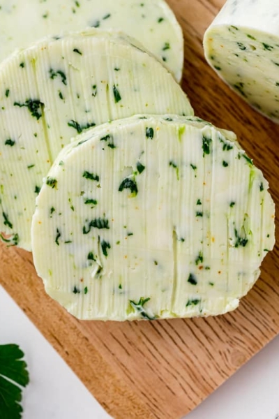 sliced of flavored butter on a wood cutting board