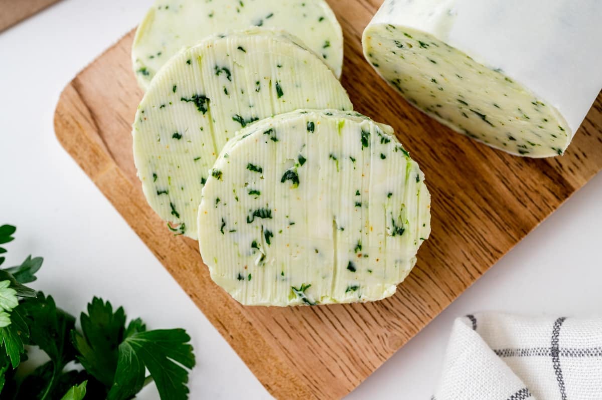 sliced of flavored butter on a wood cutting board