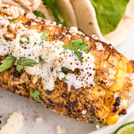 close up of mexican street corn on a plate