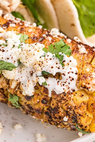 close up of mexican street corn on a plate