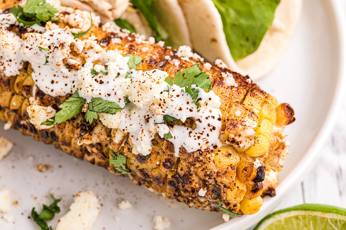 close up of mexican street corn on a plate