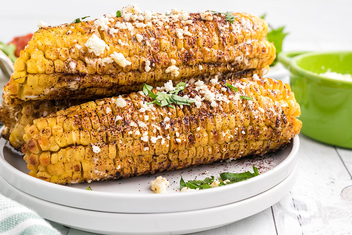 straight on shot of elotes on a plate