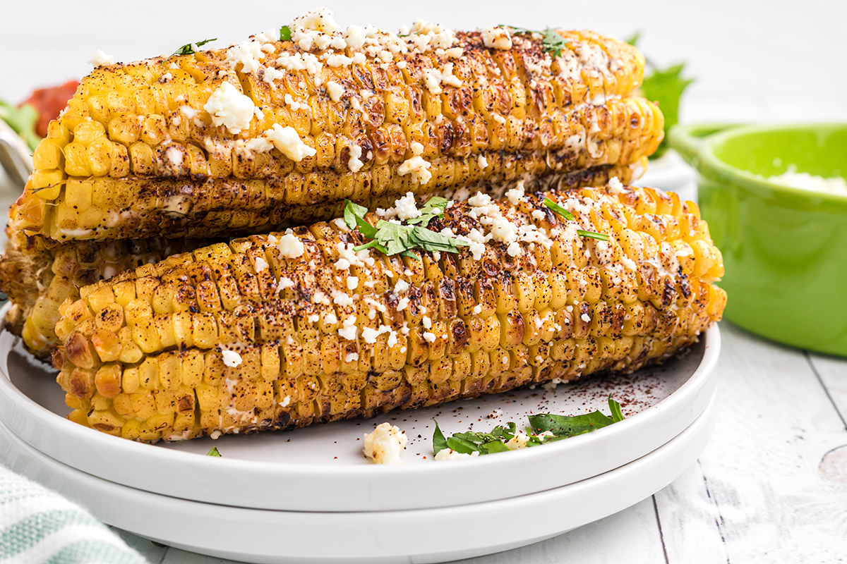 straight on shot of elotes on a plate