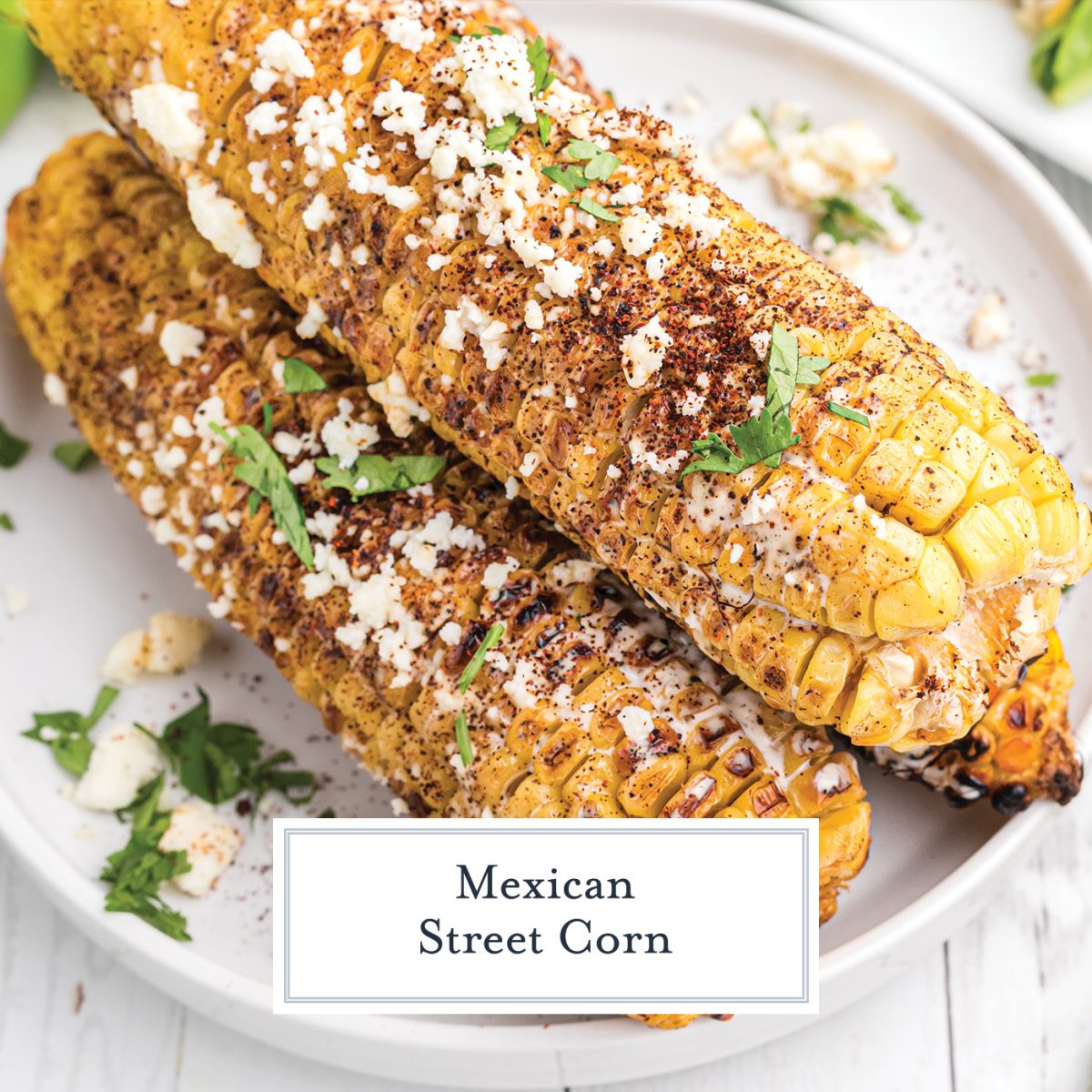 two ears of mexican street corn on a plate with text overlay for facebook