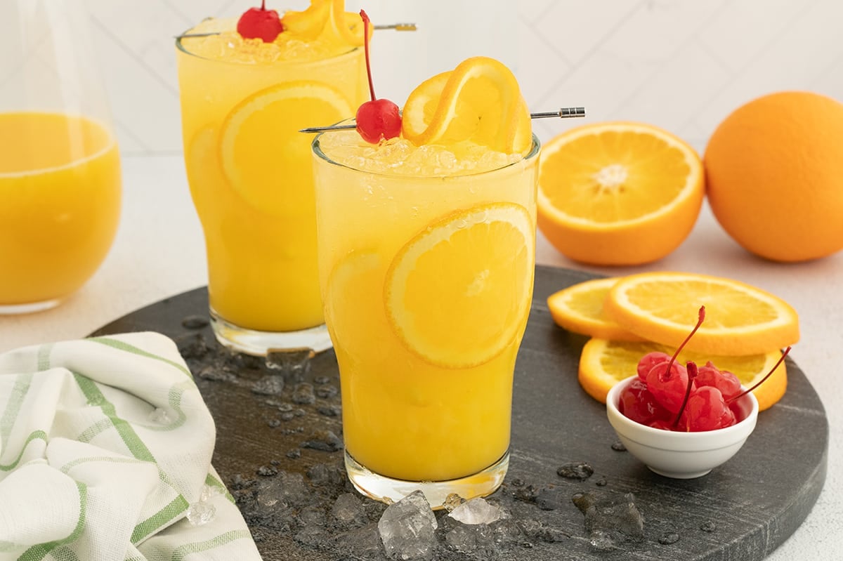 two orange crush cocktails on a tray
