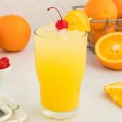 orange crush cocktail with cherry and orange