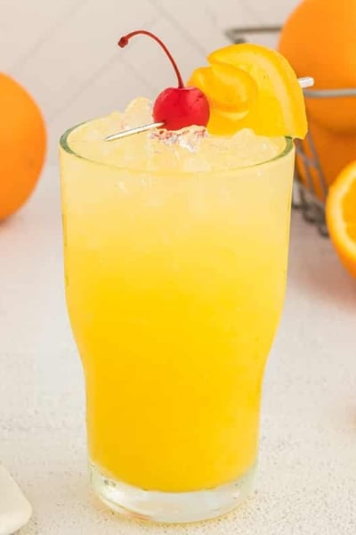 orange crush cocktail with cherry and orange