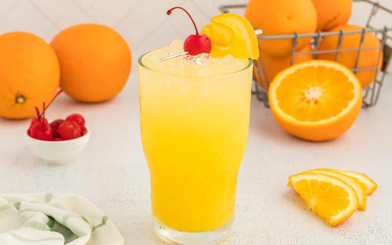 orange crush cocktail with cherry and orange
