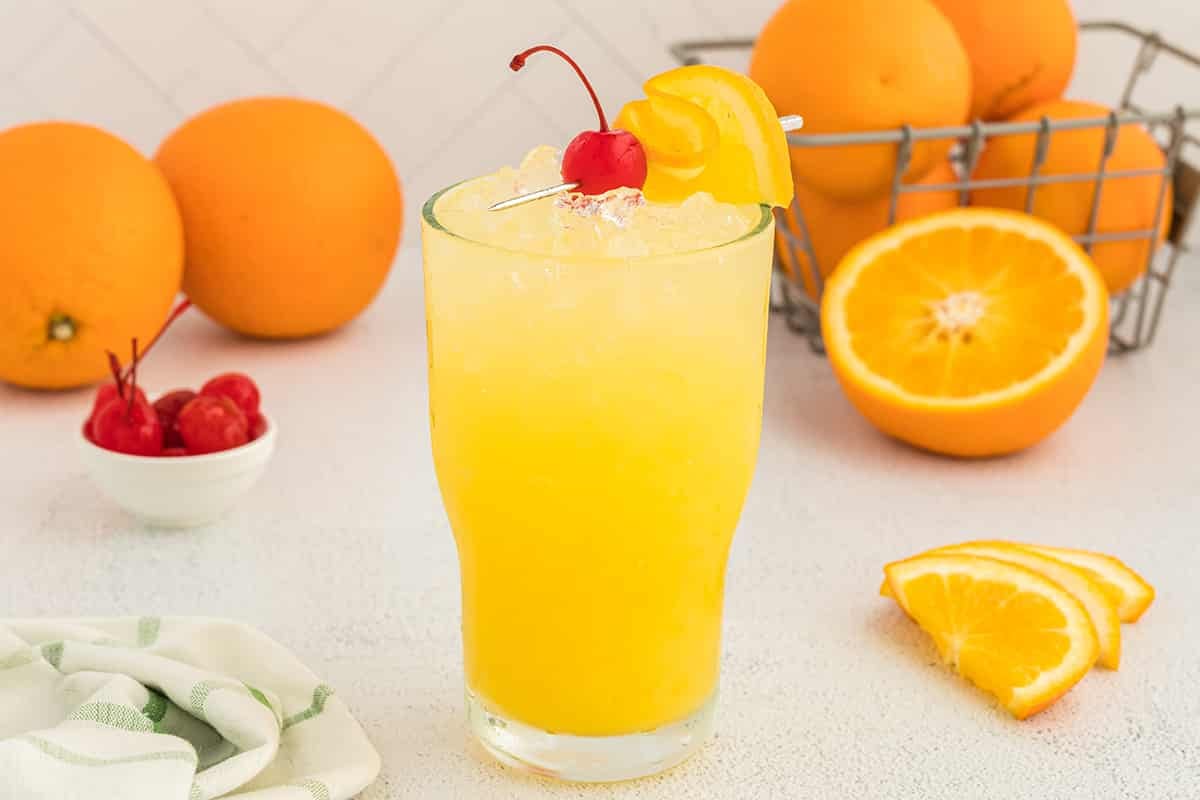 orange crush cocktail with cherry and orange
