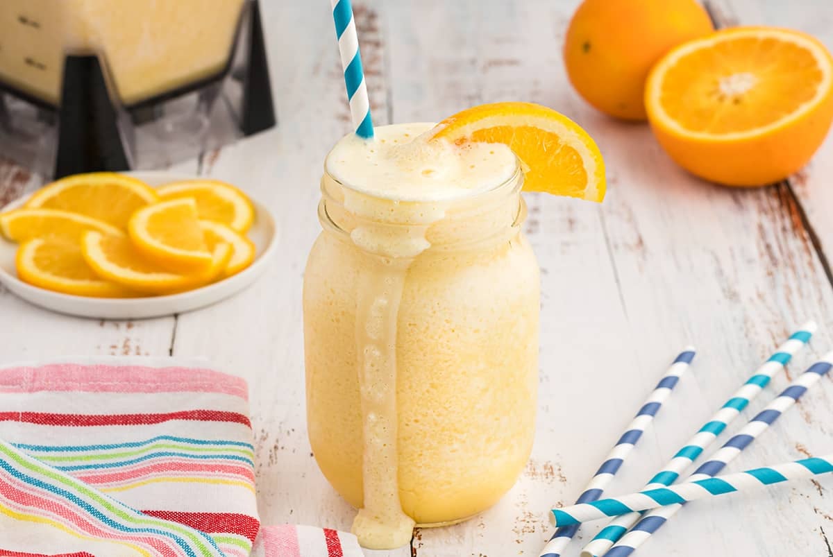 orange julius overflowing out of mason jar