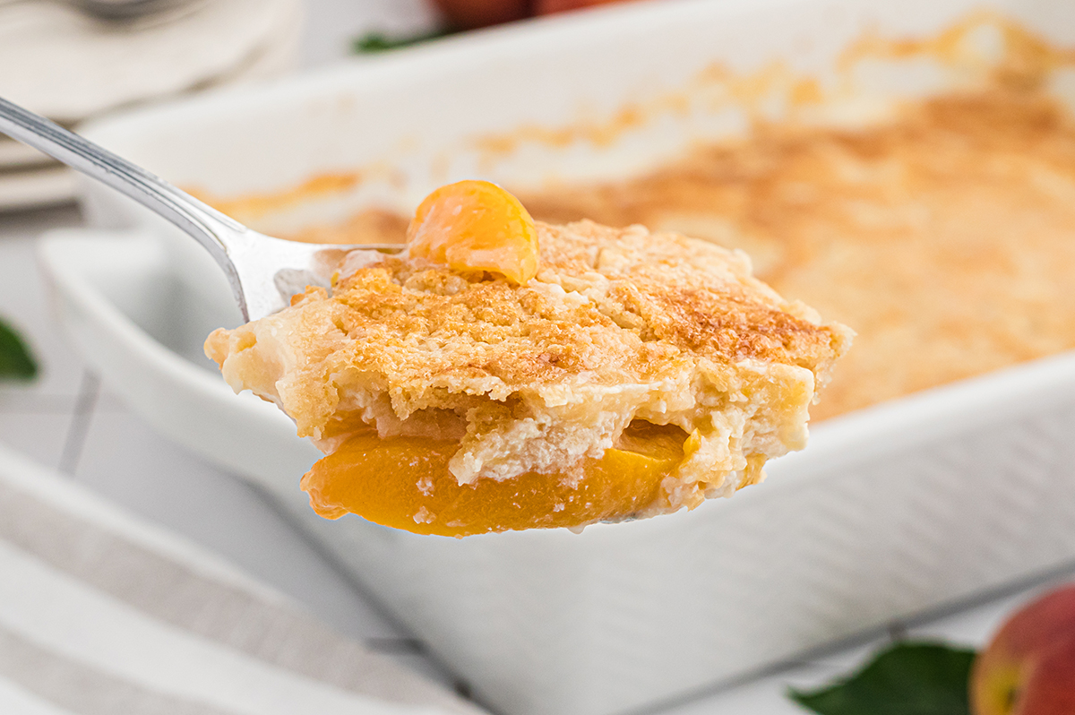 slice of peach dump cake on a spoon