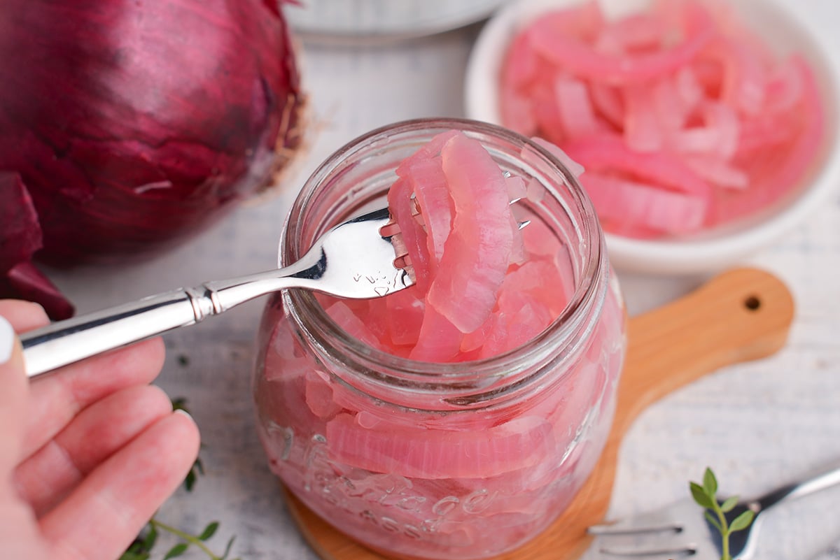 fork holding pickled red onion