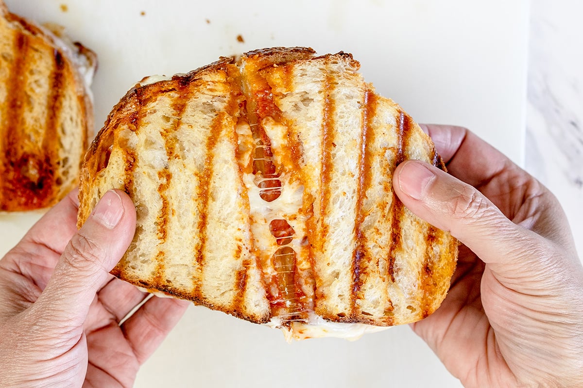 overhead shot of pizza sandwich cut in half