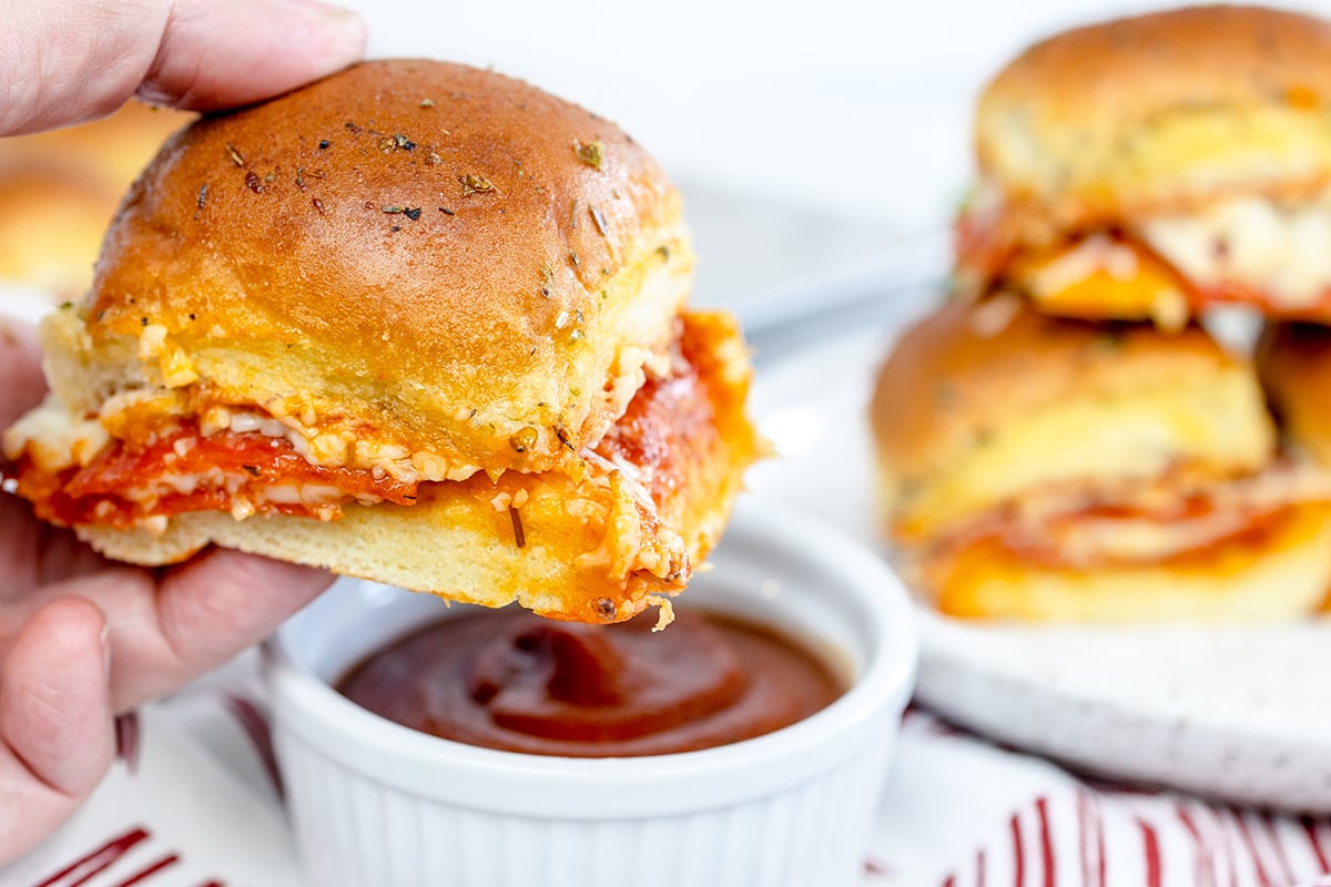 hand holding pizza slider