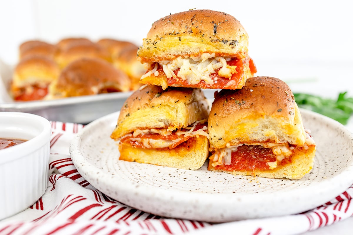 stack of three pizza sliders on a plate