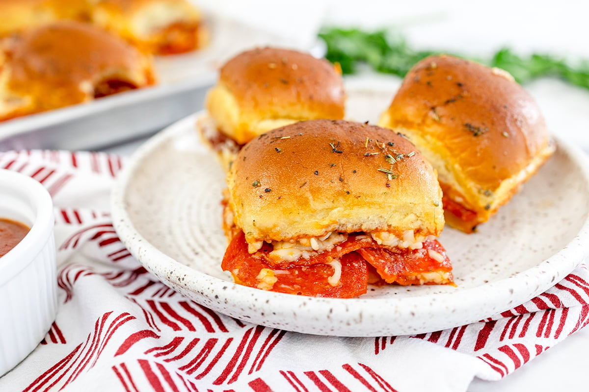 three pizza sliders on a plate