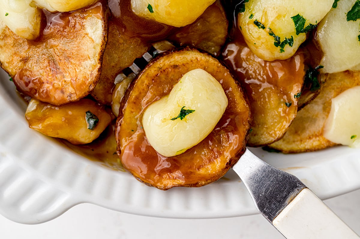 fried potatoes with gravy and melted cheese 