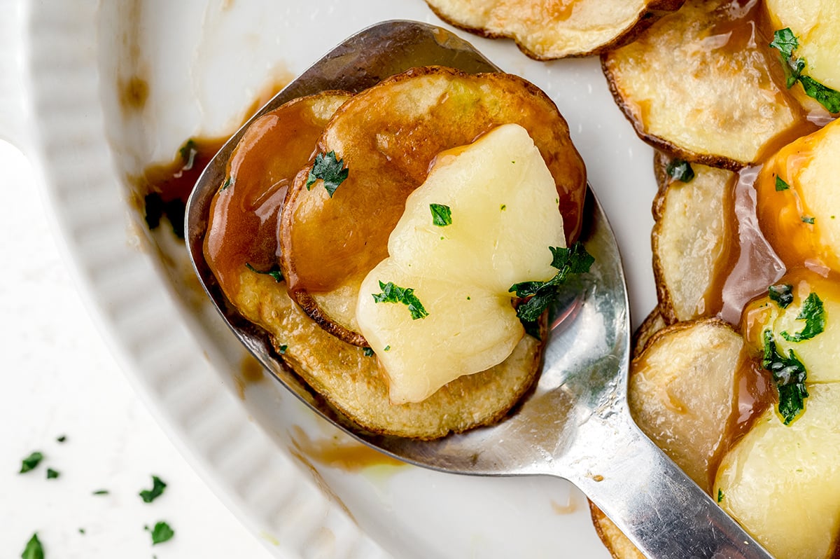 serving of poutine on a serving spoon 