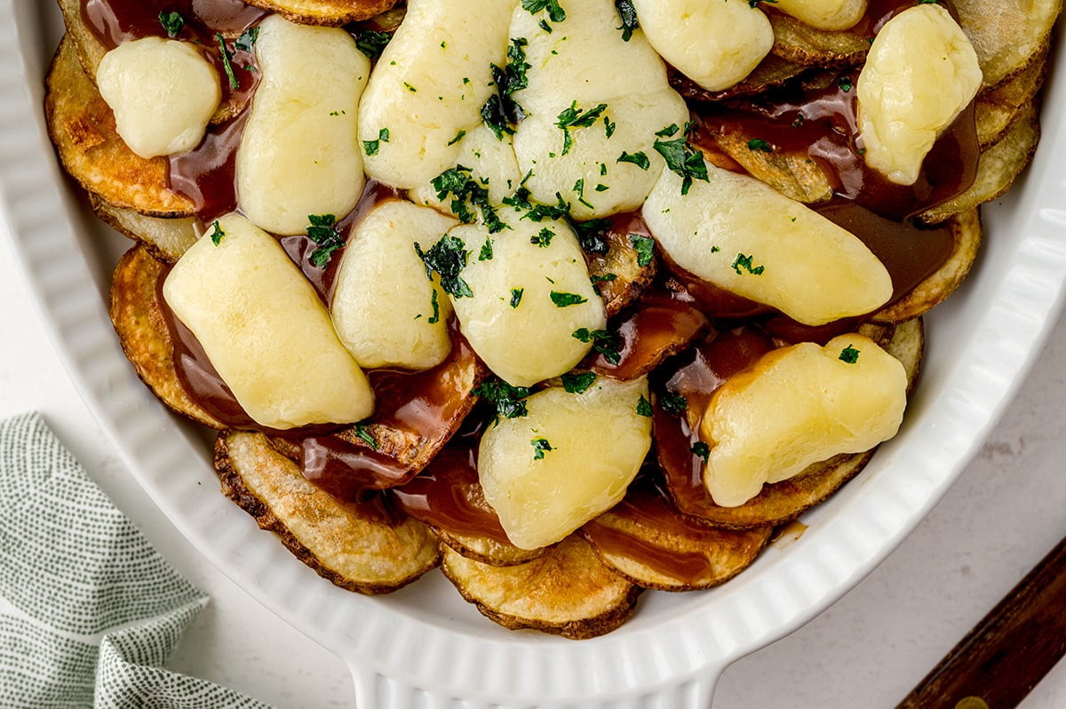 poutine made with fried potatoes, cheese, gravy and parsley 