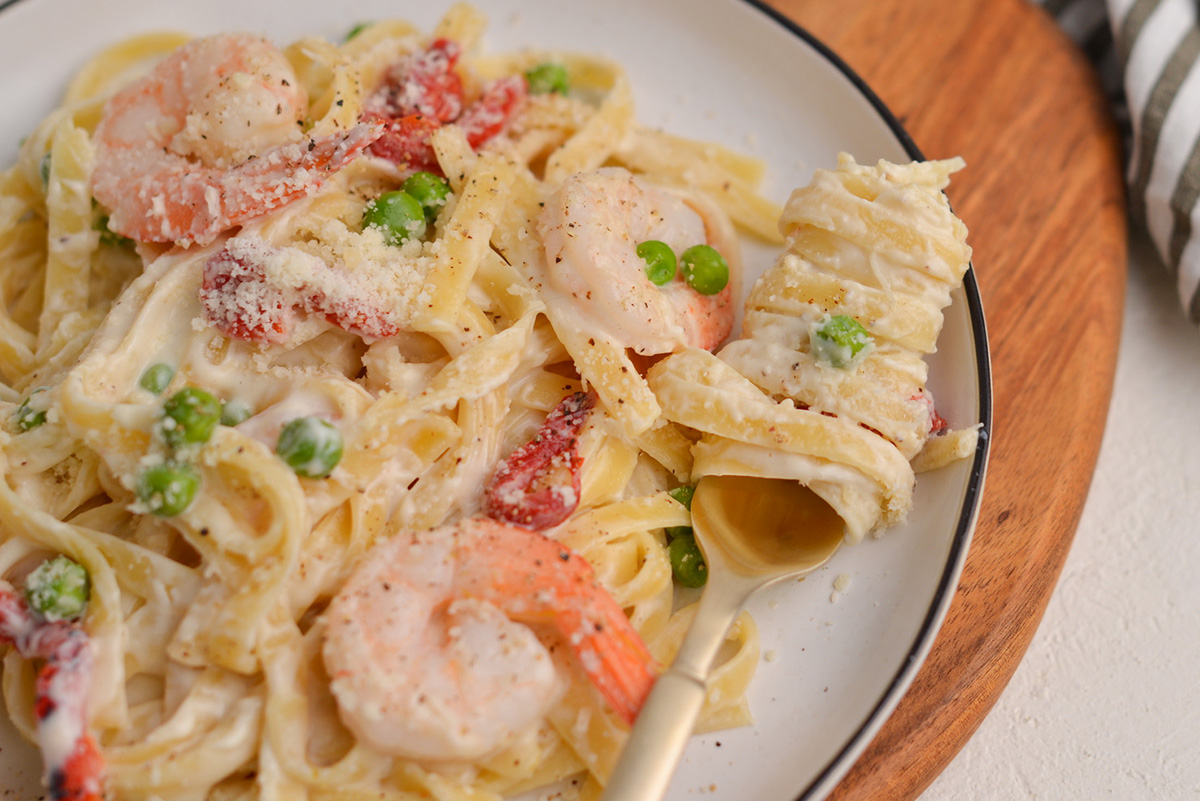 close up of pasta wrapped around a fork on a plate 