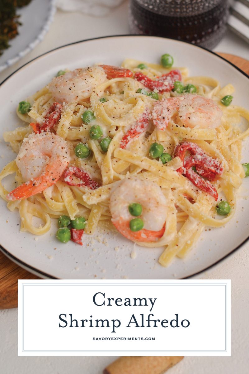 close up of shrimp alfredo with peas and roasted red peppers 
