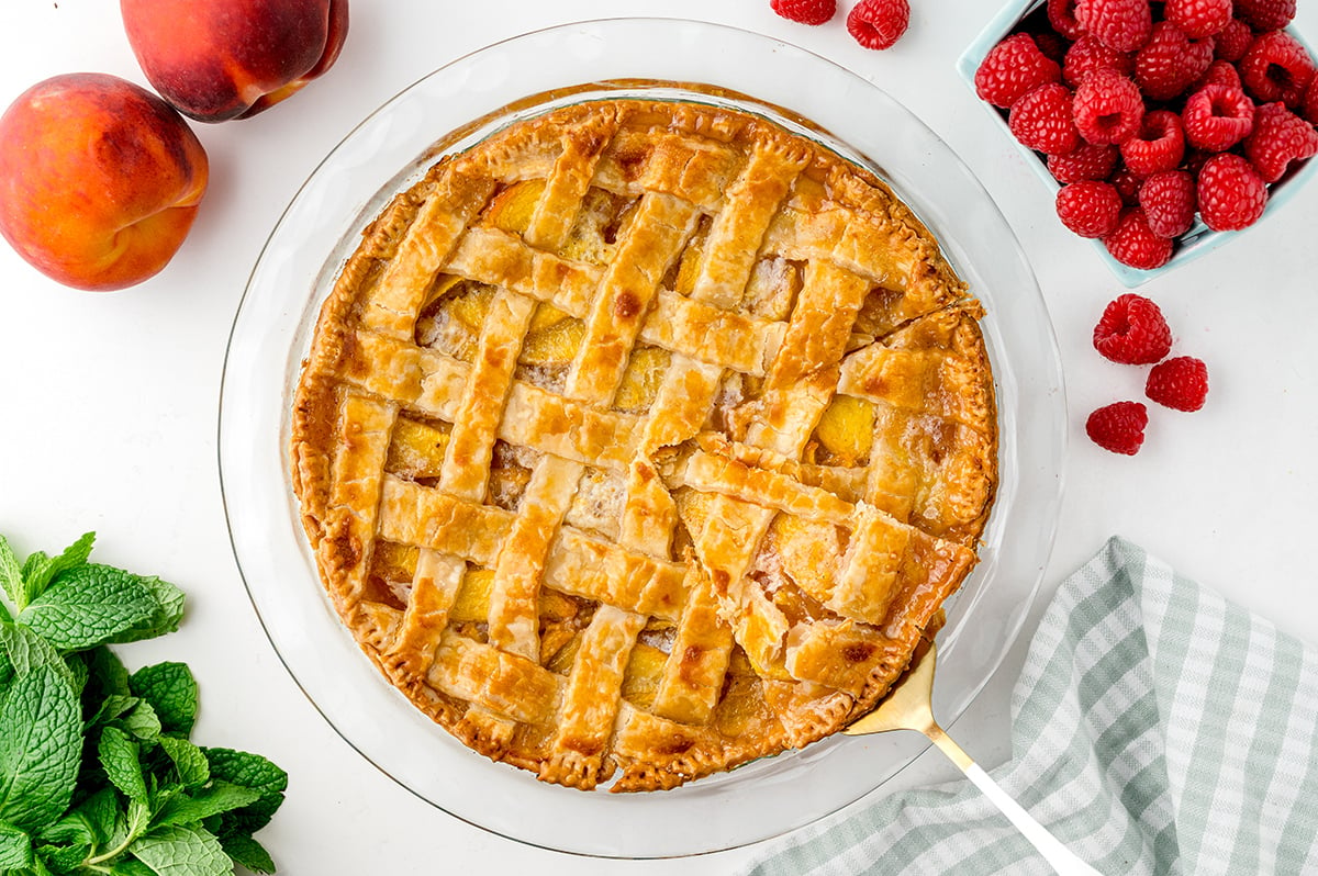 overhead shot of sliced peach pie