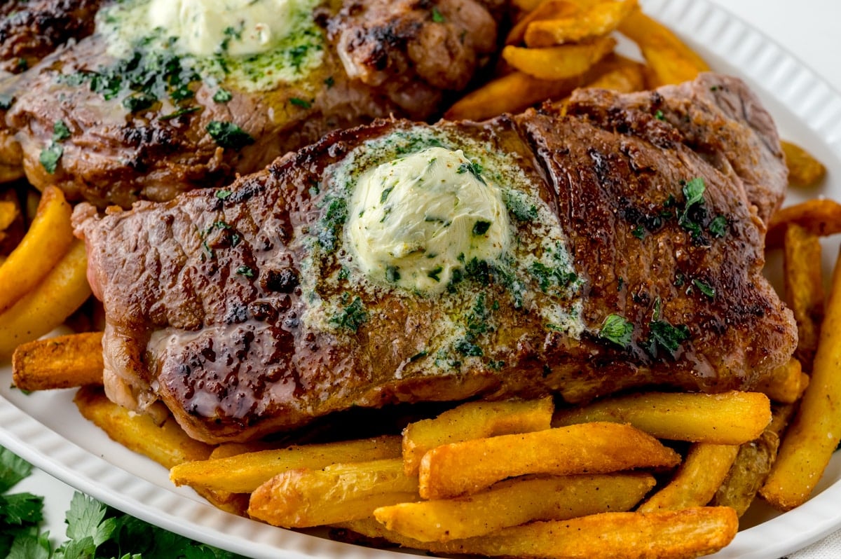 melting butter over steak frit