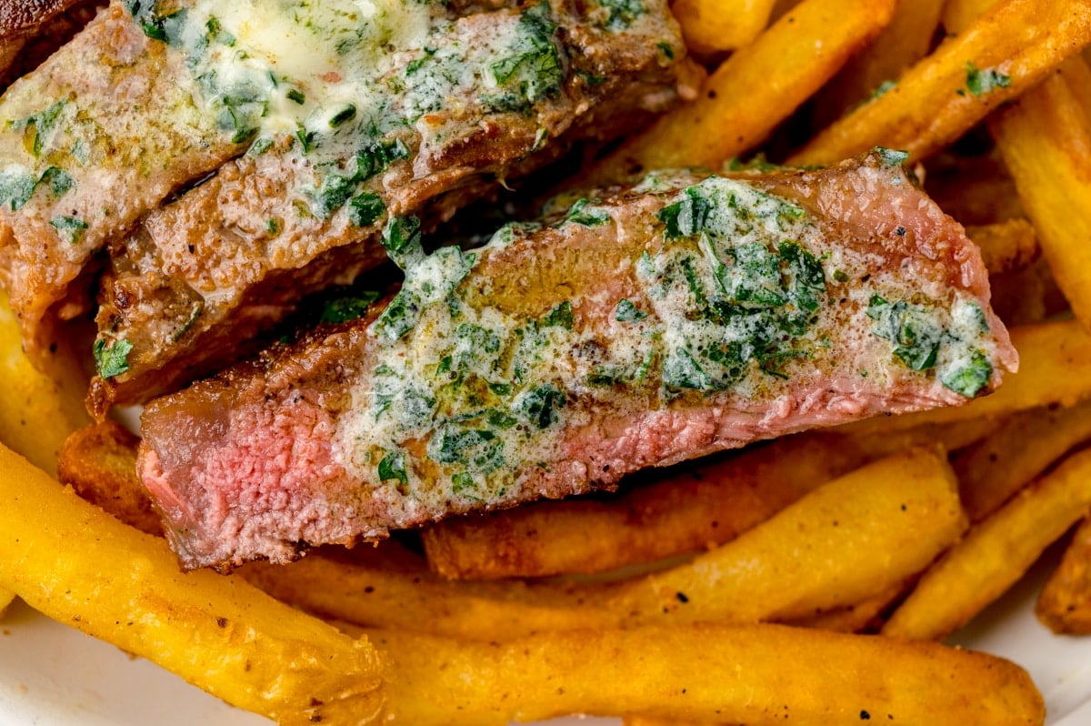 melted butter with garlic and parsley on steak
