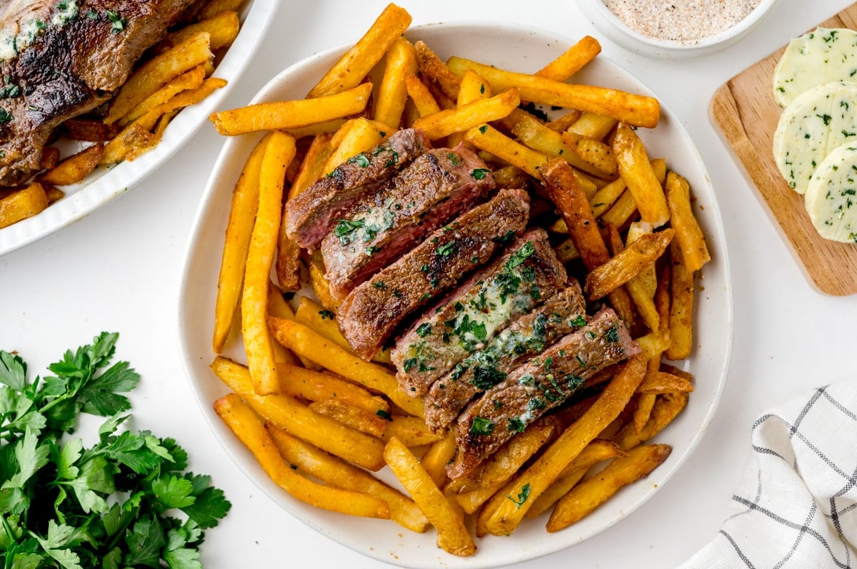 overhead shot of steak frites on a plate