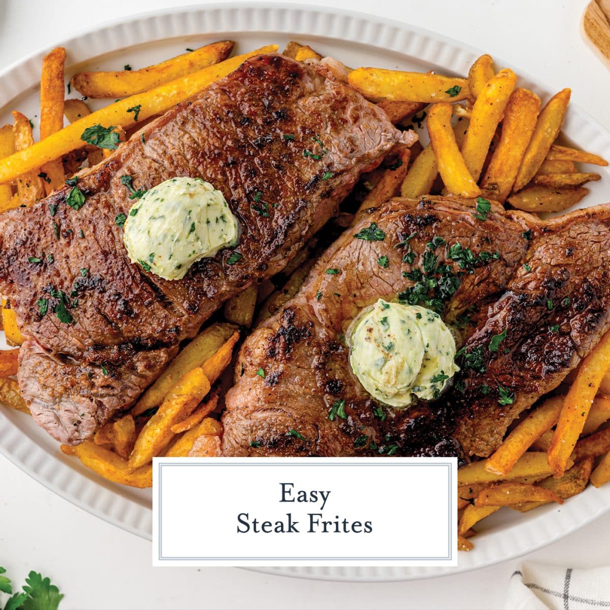 close up of two steak frites with compound butter