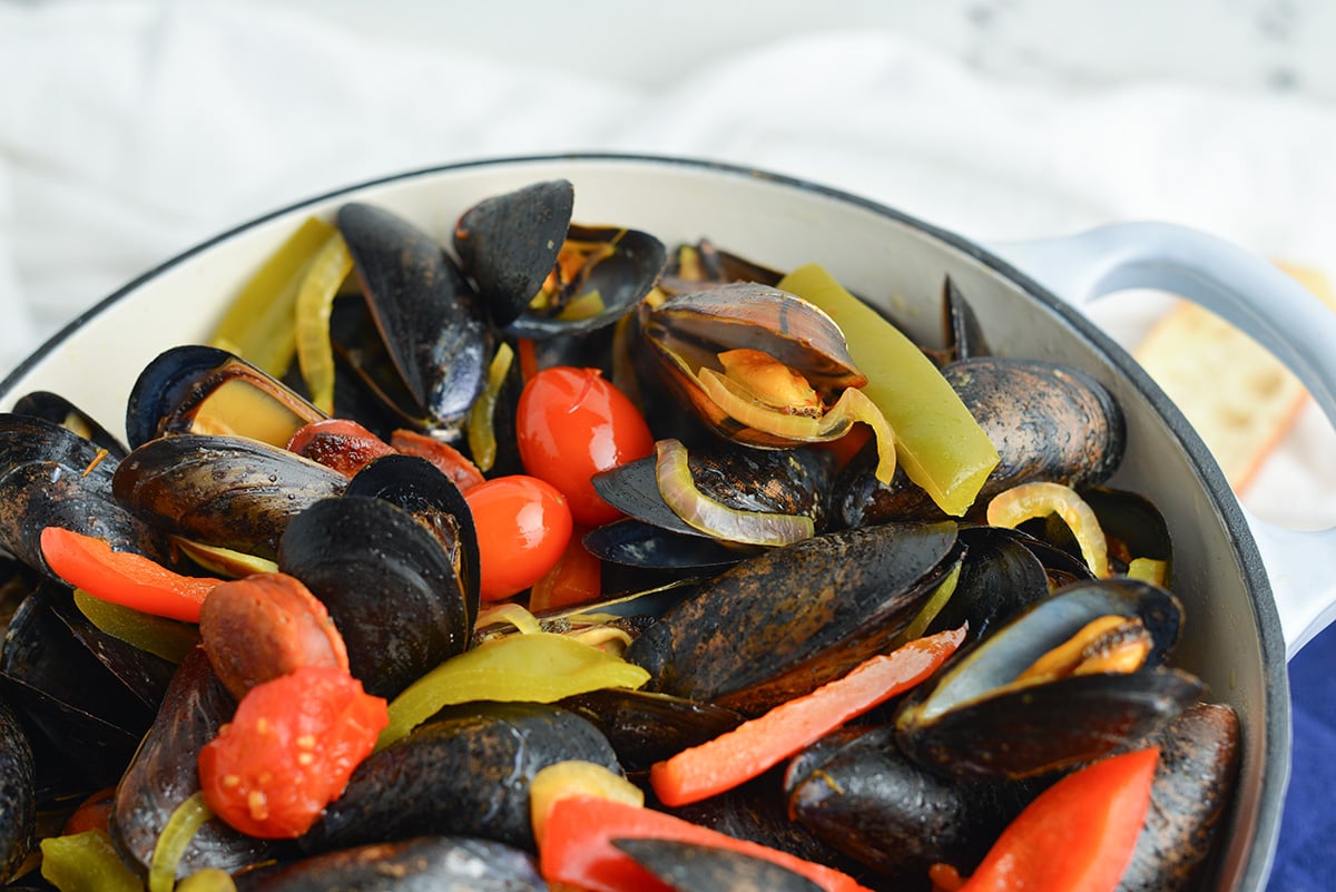 angle close up of cooked mussels in a cooking pot  