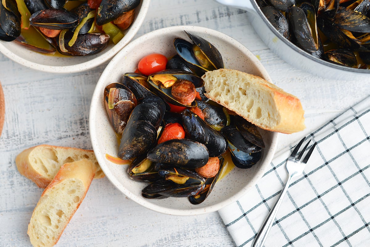 overhead of mussels with chorizo in serving bowls 