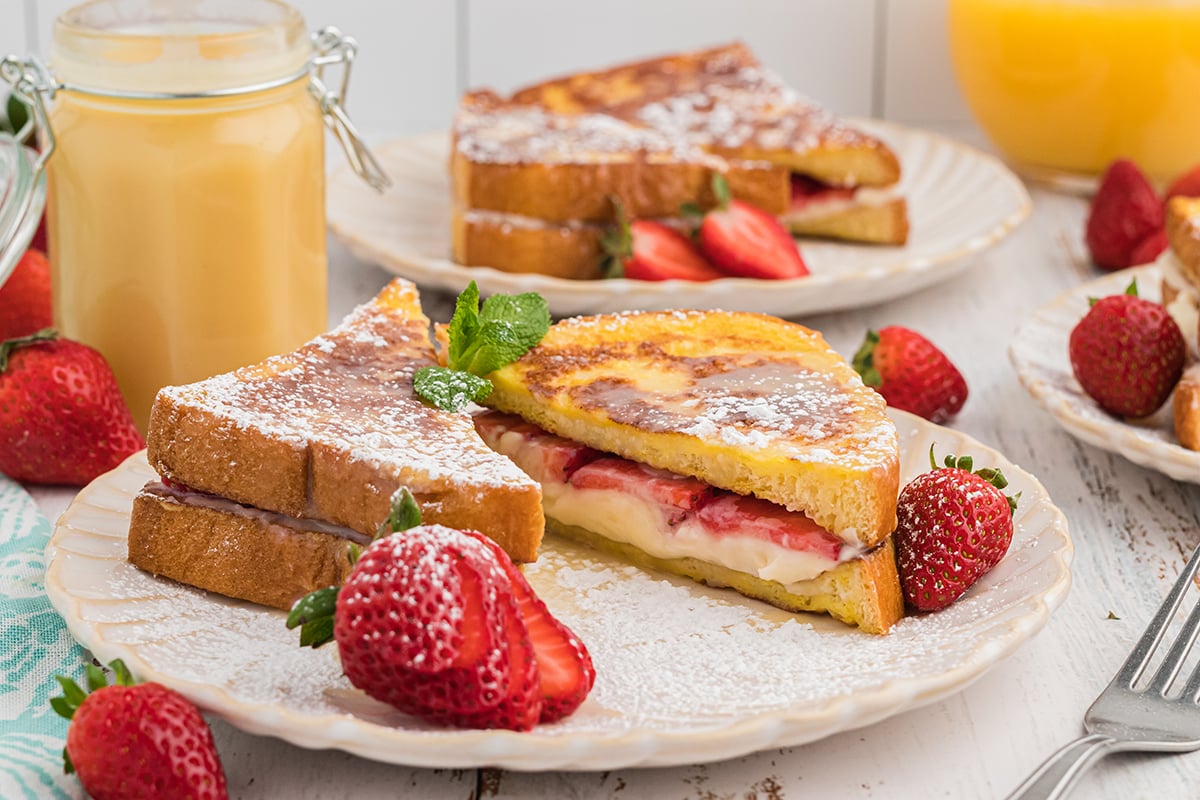 close up of stuffed french toast recipe with powdered sugar on a serving plate 