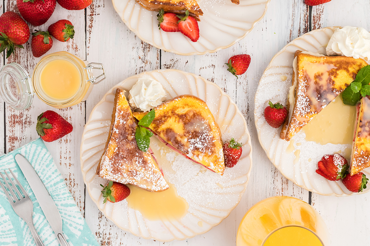 overhead of several plates of cream cheese stuffed french toast