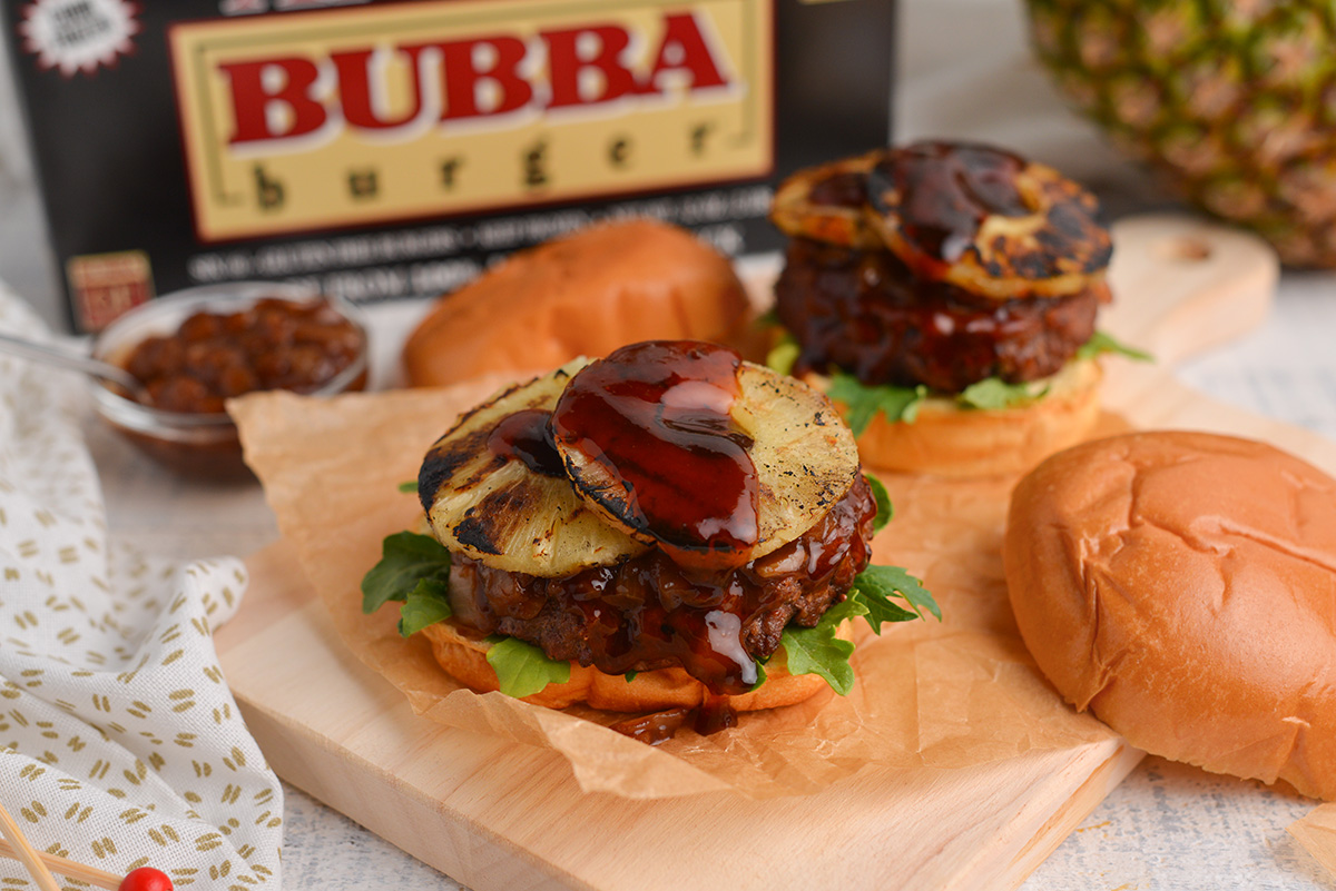 open face burger sitting on brown parchment paper 