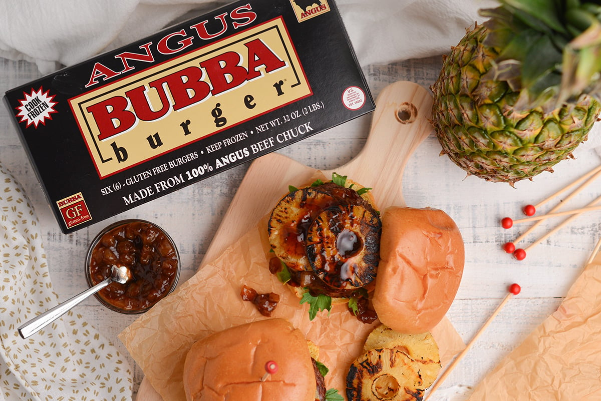 overhead of grilled pineapple on a burger with brioche buns and bubba burger box 