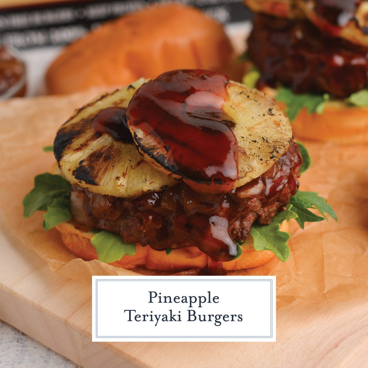 close up of a burger with grilled pineapple, teriyaki sauce, greens and onion jam