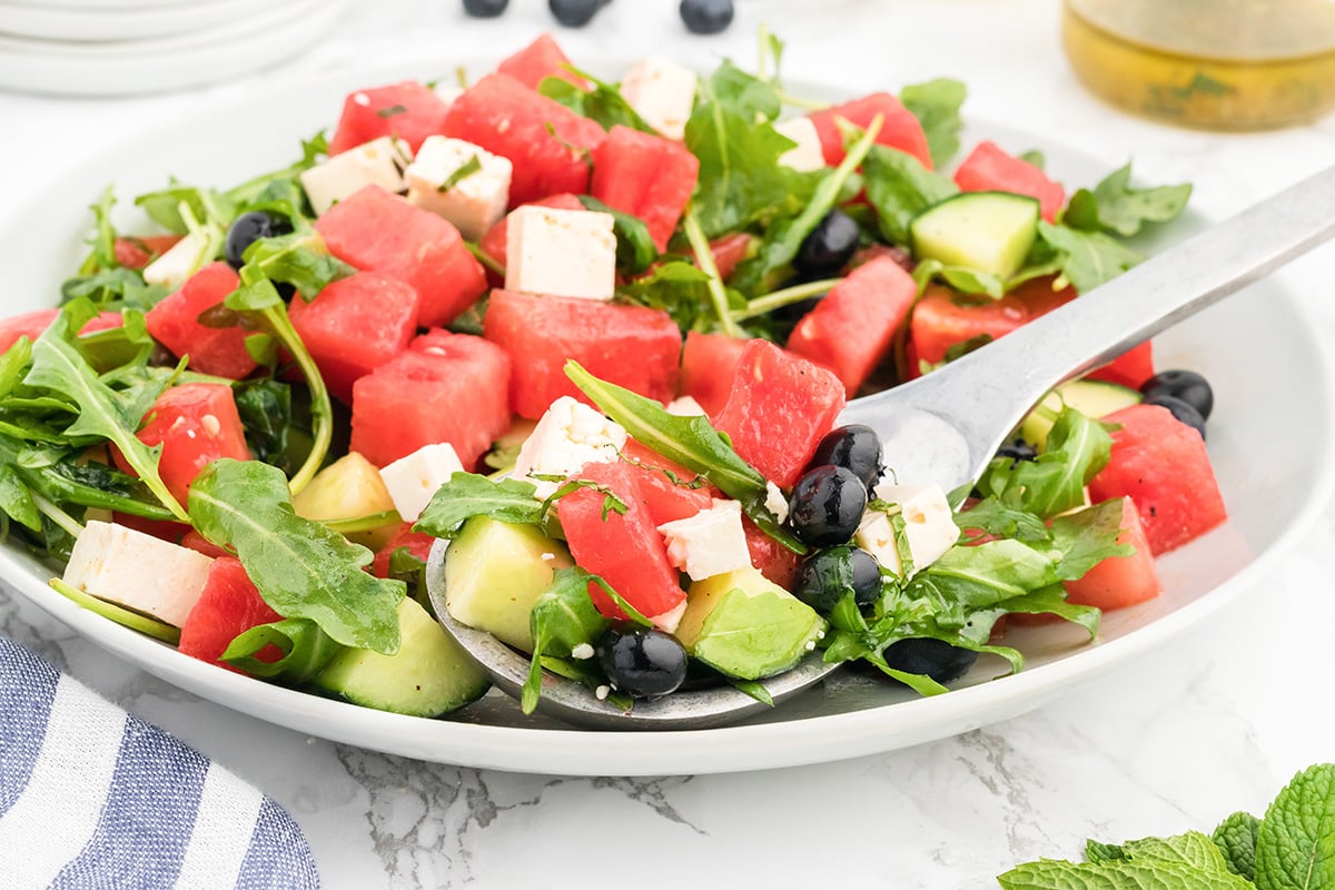bowl of watermelon feta salad with serving spoon