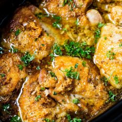 close up of chicken thighs in slow cooker