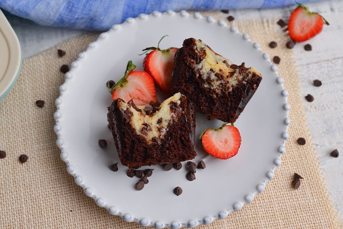 black bottom cupcakes split in half on a small white plate