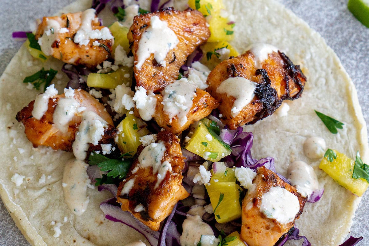 close up of baja style fish taco sauce on a fish taco