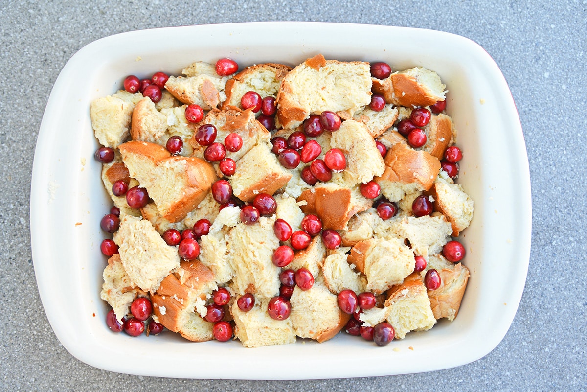 overhead of making a french toast bake with cranberries