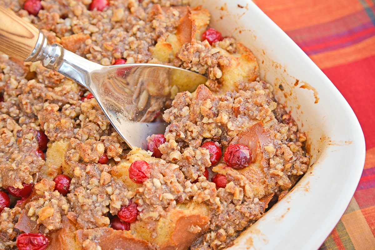 spoon digging into a cranberry french toast casserole