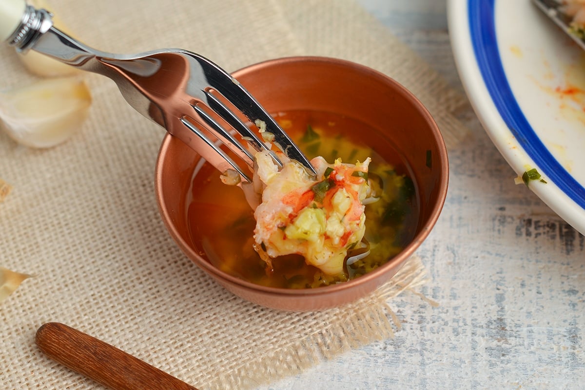 lobster bite dipping into garlic butter sauce