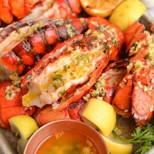 close up lobster tail with garlic butter sauce