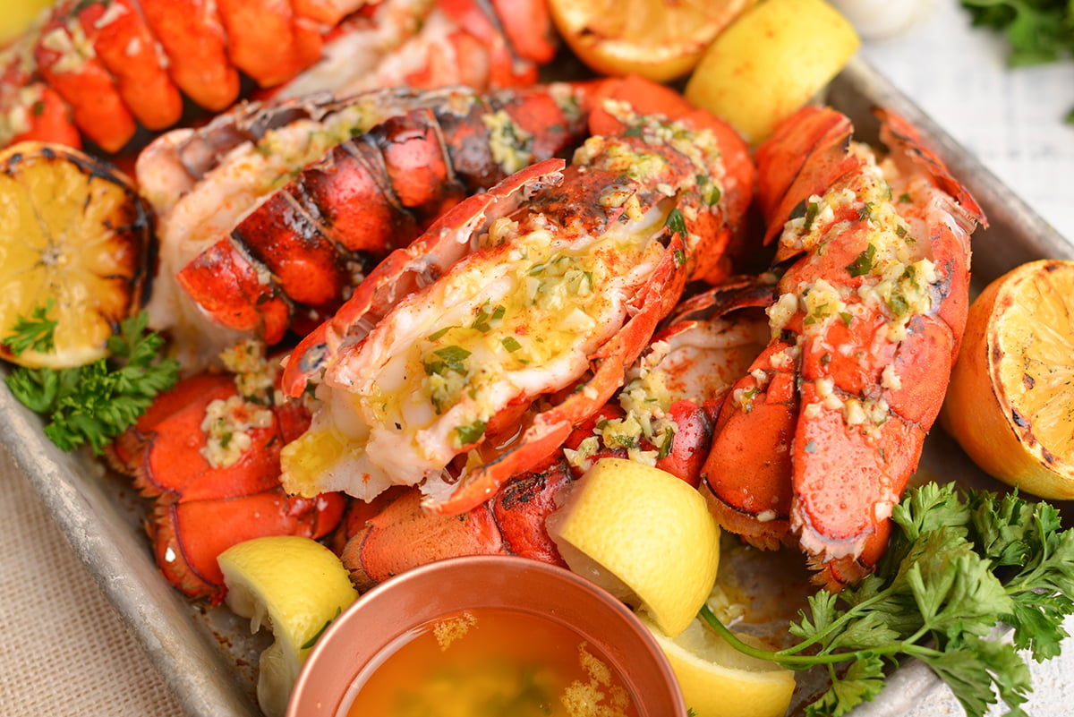 close up lobster tail with garlic butter sauce