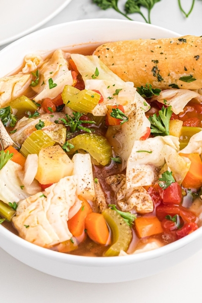 bowl of cabbage soup with breadstick