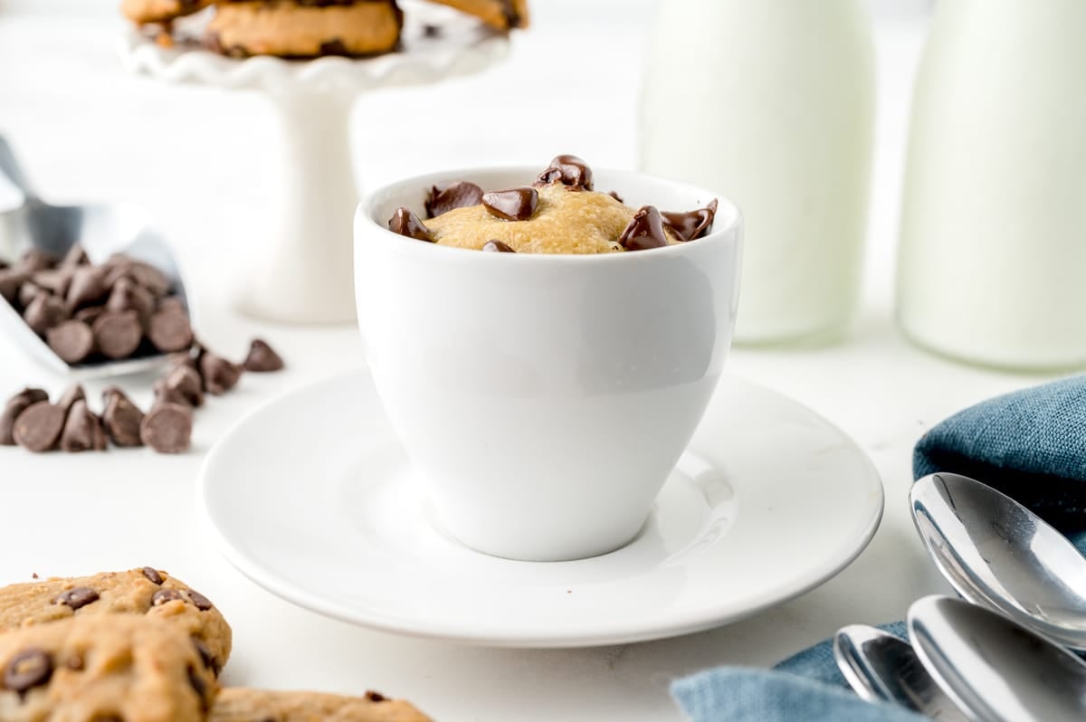 head on chocolate chip mug cookie in a white mug