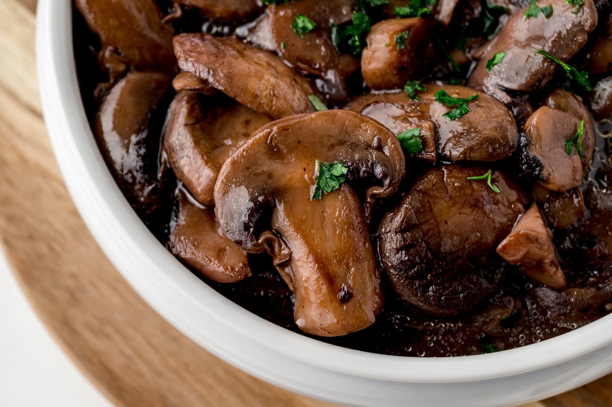 close up of a sliced mushrooms in steak sauce