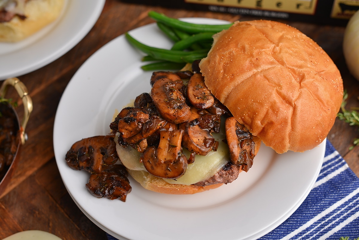 mushroom gravy running off a burger with green beans